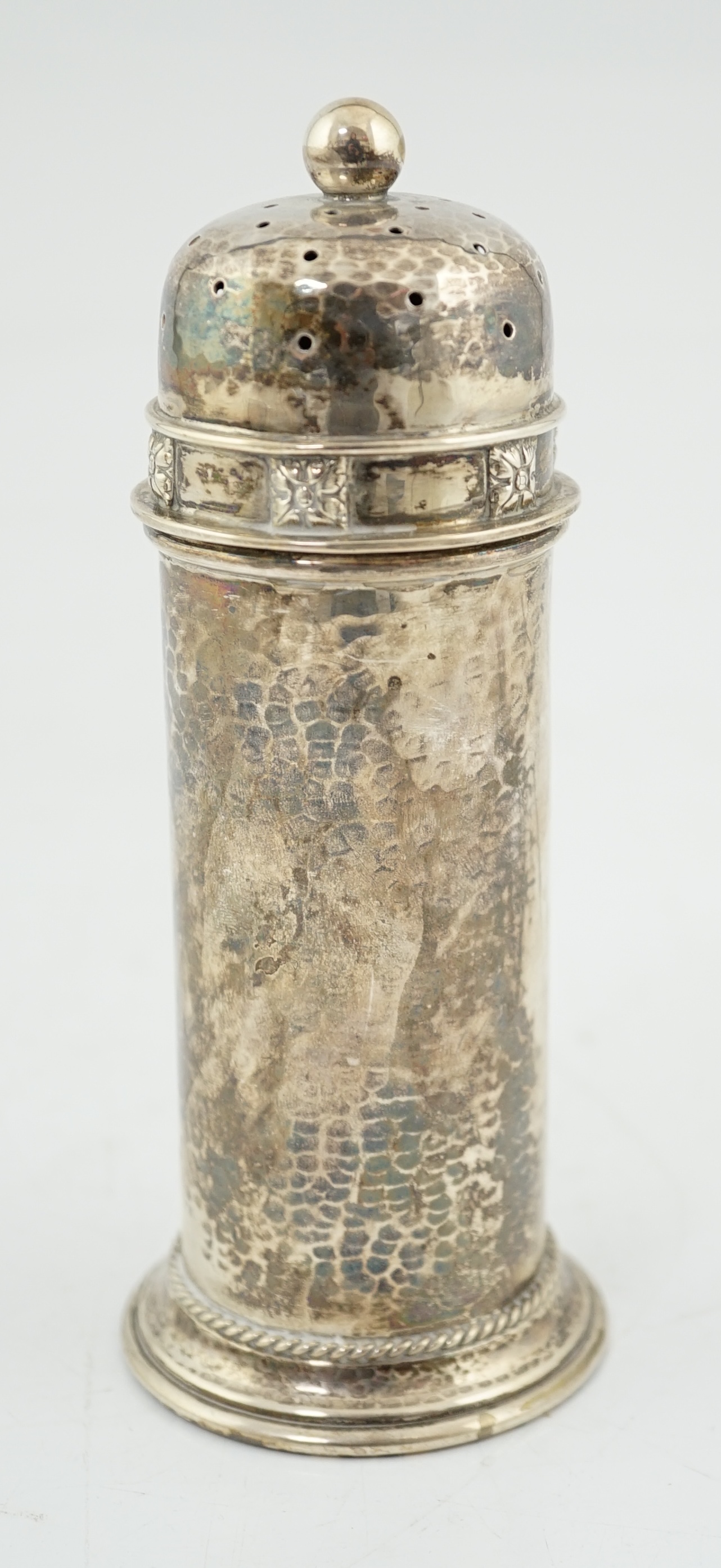 A George V Arts & Crafts planished silver sugar castor by Albert Edward Jones, of lighthouse form, Birmingham, 1929, 16.7cm, 5.3oz. Condition - fair to good